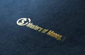 Masters of Money LLC LLC Gold Logo On Denim Surface Photo